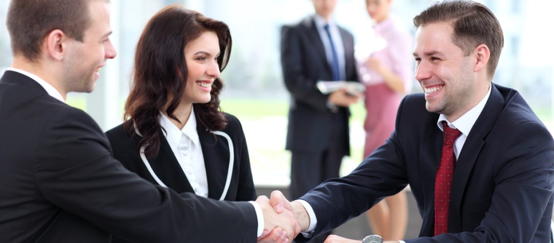 Business people shaking hands, finishing up a meeting Business people shaking hands, finishing up a meeting